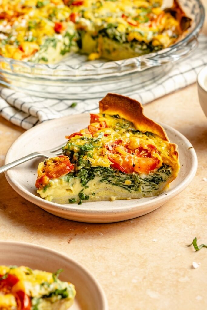 slice of tomato basil tortilla quiche on a plate